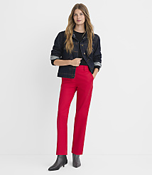 A woman in a denim jacket and red pants stands against a plain white background. carousel Product Image 1