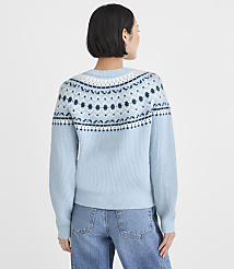 A woman wearing a light blue patterned sweater and blue jeans stands with her back to the camera against a plain white background. carousel Product Image 4