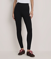 A person wearing a white top, black leggings, and brown shoes with red laces stands against a plain white background. carousel Product Image 2