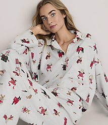 A woman wearing light grey pajamas with a red and black dog print poses against a plain white background. carousel Product Image 1