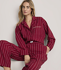A blonde woman wearing red and white striped pajamas poses against a plain white background. carousel Product Image 2