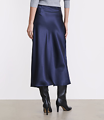 A person wearing a grey top, a long navy blue satin skirt, and black heeled boots stands against a plain white background. carousel Product Image 3