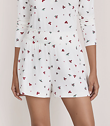 A person wears a white floral print pajama set against a plain, light-colored background. carousel Product Image 2