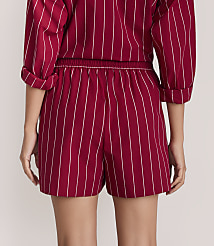 A person wearing a red and white pinstriped matching set stands against a plain, light-colored background. carousel Product Image 3