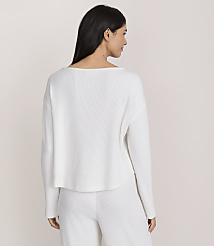 A woman with long dark hair wearing a white ribbed long-sleeved top and matching pants stands against a plain light-colored background. carousel Product Image 3