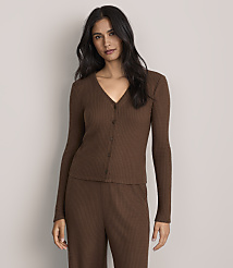 A woman wearing a brown ribbed knit lounge set stands against a plain, light-colored background. carousel Product Image 1