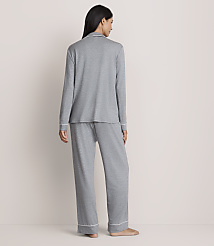 A woman stands with her back to the camera wearing grey pajamas against a plain, light-colored wall. carousel Product Image 3