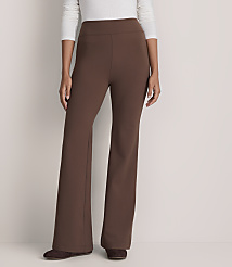 A person wearing a white long-sleeved shirt and brown wide-leg trousers stands against a plain, light-colored background. carousel Product Image 2