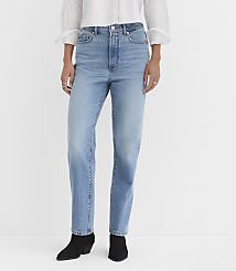 A person wearing light-wash jeans and black boots stands against a plain white background. carousel Product Image 1