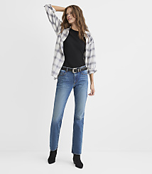 A woman wearing a black t-shirt, an open plaid shirt, blue jeans, and black boots stands against a plain white background. carousel Product Image 1