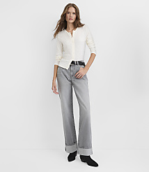 A woman wearing a white textured shirt and wide-leg grey jeans stands against a plain white background. carousel Product Image 1