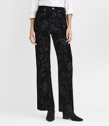A person wears black floral velvet trousers, a white shirt, and black boots against a plain white background. carousel Product Image 2