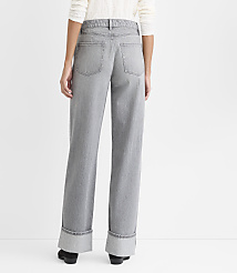 A person stands facing away from the camera wearing wide-leg grey jeans and a white top against a plain white background. carousel Product Image 2