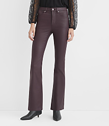 A person wears burgundy faux-leather flare pants and black boots against a plain white background. carousel Product Image 2