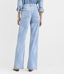 A person wearing a light blue denim shirt and floral-patterned wide-leg jeans stands against a plain white background. carousel Product Image 3