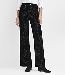 A person wearing a white shirt and black floral-patterned wide-leg pants stands against a plain white background. carousel Product Image 1