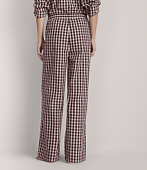 A person wearing black and white checkered pajama pants stands against a plain, light-colored background. carousel Product Image 3