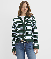 A woman wearing a green and blue striped cardigan and blue jeans stands against a plain white background. carousel Product Image 2