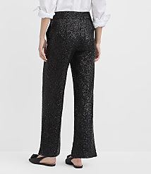 A person wearing a white shirt and shimmering black sequined pants stands against a plain white background. carousel Product Image 2