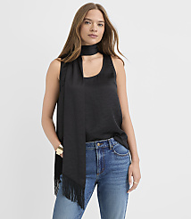 A woman wearing a black sleeveless top, a black scarf, and blue jeans stands against a plain white background. carousel Product Image 1