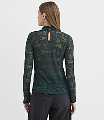 A woman stands with her back to the camera wearing a dark green lace top and black pants against a plain white background. carousel Product Image 3
