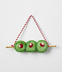 Three green felt sushi rolls on a wooden skewer with a red and white string hanger against a plain white background. carousel Product Image 1