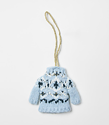 A small, blue knitted sweater ornament with a gold string hangs against a plain white background. carousel Product Image 1