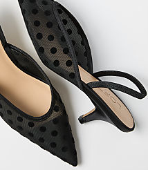 Two black polka-dot mesh pointed-toe heels rest on a plain white background. carousel Product Image 2