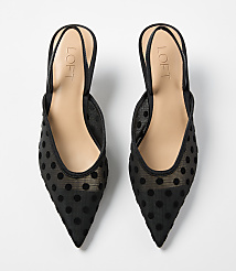 A pair of black polka-dot mesh pointed-toe mules with tan insoles rests on a plain white background. carousel Product Image 3