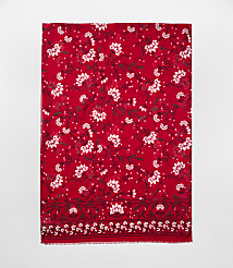 A red scarf with white floral patterns is centered against a plain light gray background. carousel Product Image 2