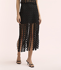 A person wears a black lace-patterned dress and black sandals against a plain light pink background. carousel Product Image 2