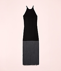 A black sleeveless dress with a fringed hem is centered against a solid light pink background. carousel Product Image 4