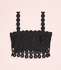 A black lace crop top with circular patterns is centered against a plain light pink background. carousel Product Image 4