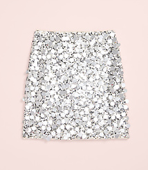 A shimmering silver sequined fabric piece rests on a solid light pink background. carousel Product Image 4