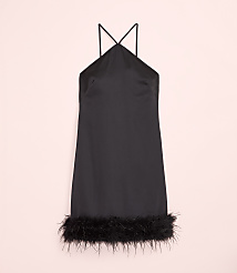 A short black satin dress with feather trim at the hem is centered against a pale pink background. carousel Product Image 4