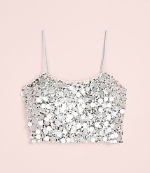 A silver sequined crop top with thin straps is centered against a solid light pink background. carousel Product Image 4