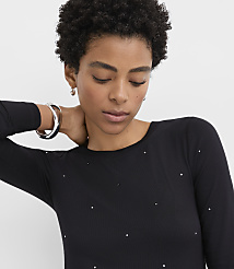 A woman with curly hair wearing a black rhinestone-embellished top and silver jewelry poses against a plain white background. carousel Product Image 4