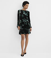A woman wearing a black and green floral velvet dress and black heels stands against a plain white background. carousel Product Image 2