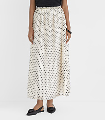 A person wearing a white polka-dot maxi skirt and black shoes stands against a plain white background. carousel Product Image 2