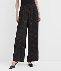 A person wearing black polka-dot wide-leg pants and black heels stands against a plain white background. carousel Product Image 3