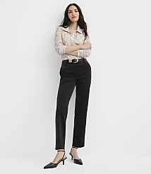 A woman wearing a lace blouse, black trousers, and pointed heels stands against a plain white background. carousel Product Image 1