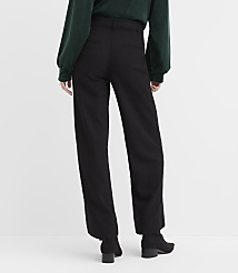A person wearing a dark green top and black wide-leg trousers stands against a plain white background. carousel Product Image 3