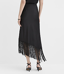 A person wearing a black midi dress with a fringed hem and black strappy heels stands against a plain white background. carousel Product Image 3