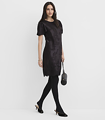 A woman wearing a black floral dress, tights, and heels stands against a plain white background. carousel Product Image 2