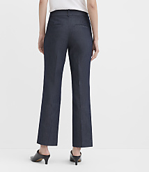 A person wearing dark blue trousers and black mules stands against a plain white background. carousel Product Image 2