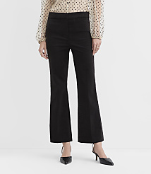 A person wearing a polka-dot blouse, black flared trousers, and black pointed-toe heels stands against a plain white background. carousel Product Image 2
