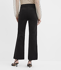 A person wearing a polka-dot blouse, black wide-leg trousers, and black heels stands against a plain white background. carousel Product Image 3
