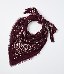 A maroon paisley-patterned bandana with frayed edges is tied in a knot against a plain white background. carousel Product Image 1
