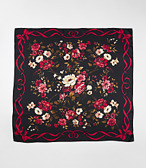 A black square scarf featuring a vibrant red and white floral pattern in the center, framed by a red ribbon border, set against a plain light gray background. carousel Product Image 2