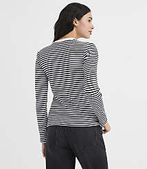 A woman wearing a black and white striped long-sleeve shirt and black pants stands against a plain white background. carousel Product Image 3